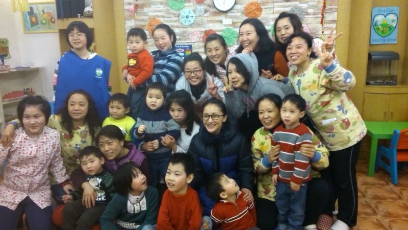 Zhou Xun with children and carers at Blue Sky Healing Home